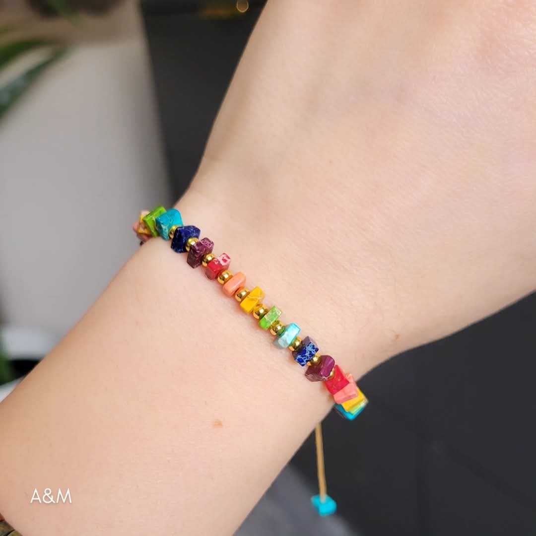 Handmade rainbow beaded bracelet with colorful square beads and gold spacers on adjustable cord – vibrant unisex jewelry accessory