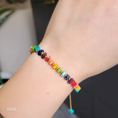 Handmade rainbow beaded bracelet with colorful square beads and gold spacers on adjustable cord – vibrant unisex jewelry accessory