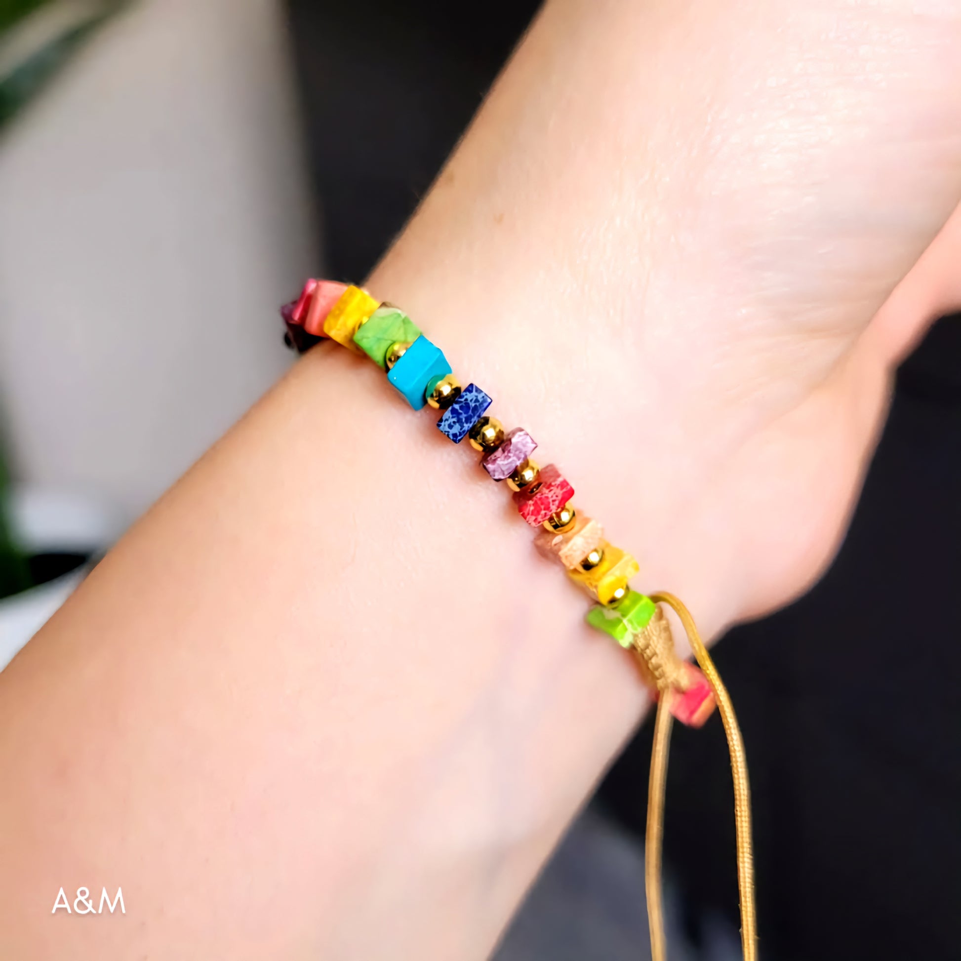 Handmade rainbow beaded bracelet with colorful square beads and gold spacers on adjustable cord – vibrant unisex jewelry accessory