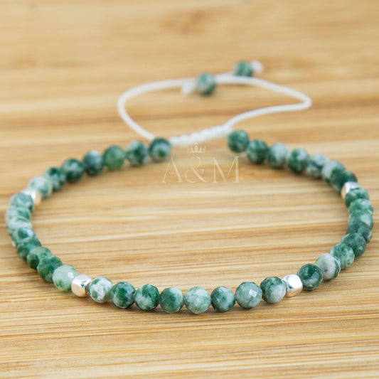 Handmade minimalist bracelet featuring 4mm faceted green spot jasper beads, known for their unique green patterns and grounding properties. Adjustable design, perfect for adding a nature-inspired, earthy touch to your jewelry collection or as a thoughtful gift.